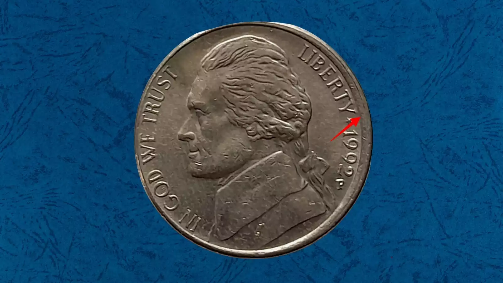 1992 nickel off-center strike error showing design shifted off-center with blank planchet crescent and visible date
