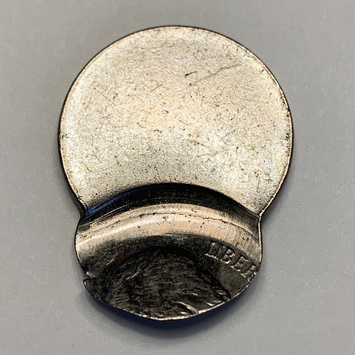 1992 nickel broadstrike error showing wider diameter and flat spread-out rim compared to normal